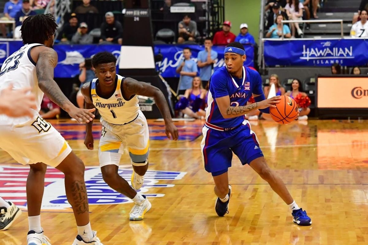 Nov 21, 2023; Honolulu, HI, USA; Kansas Jayhawks guard Dajuan Harris Jr. (3) drives the ball downcourt against Marquette Golden Eagles guard Kam Jones (1) and David Joplin (23) during the first period at SimpliFi Arena at Stan Sheriff Center.