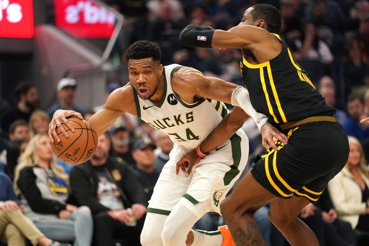Mar 6, 2024; San Francisco, California, USA; Milwaukee Bucks forward Giannis Antetokounmpo (34) dribbles the ball next to Golden State Warriors forward Jonathan Kuminga (00) in the second quarter at the Chase Center.