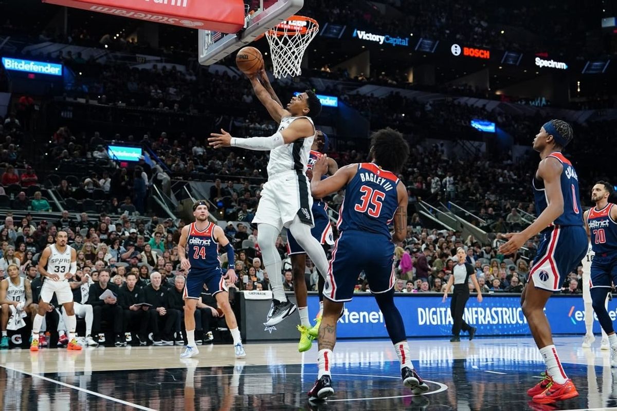 Jan 29, 2024; San Antonio, Texas, USA;  San Antonio Spurs forward Keldon Johnson (3) goes up for a shot in front of Washington Wizards forward Marvin Bagley III (35) in the first half at Frost Bank Center.