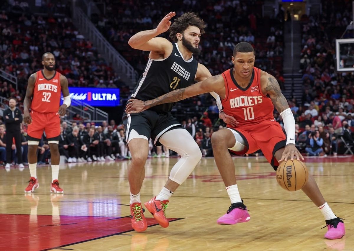 Dec 13, 2023; Houston, Texas, USA; Houston Rockets forward Jabari Smith Jr. (10) dribbles against Memphis Grizzlies forward David Roddy (21) in the second half at Toyota Center.