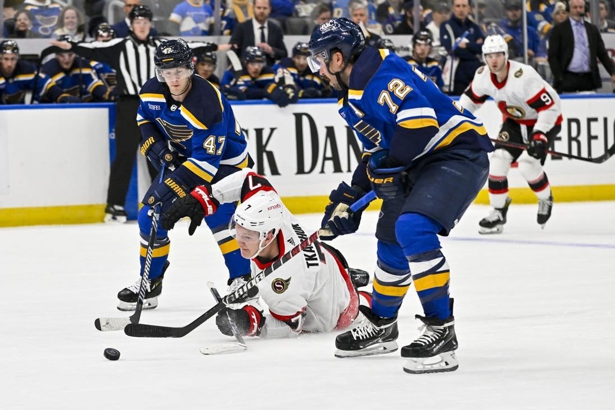 Dec 14, 2023; St. Louis, Missouri, USA;  Ottawa Senators left wing Brady Tkachuk (7) falls to the ice as St. Louis Blues defenseman Torey Krug (47) and defenseman Justin Faulk (72) defend during the first period at Enterprise Center.