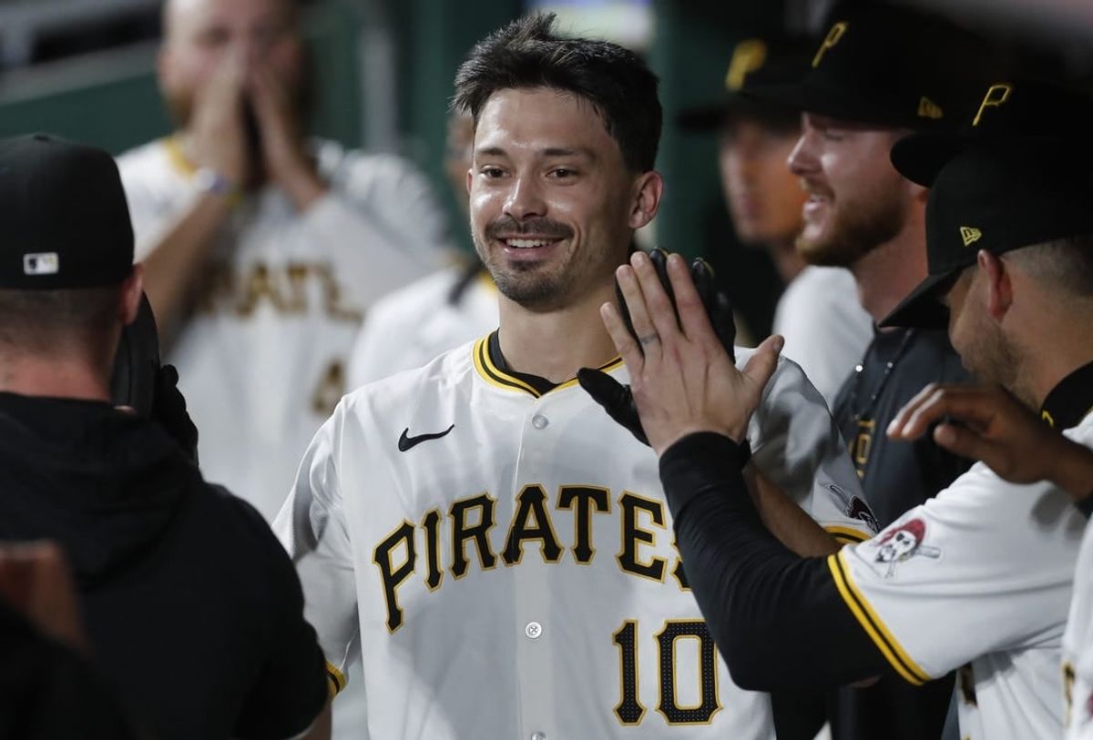 Apr 8, 2024; Pittsburgh, Pennsylvania, USA;  Pittsburgh Pirates left fielder Bryan Reynolds (10) celebrates his solo home run in the dugout against the Detroit Tigers during the sixth inning at PNC Park.