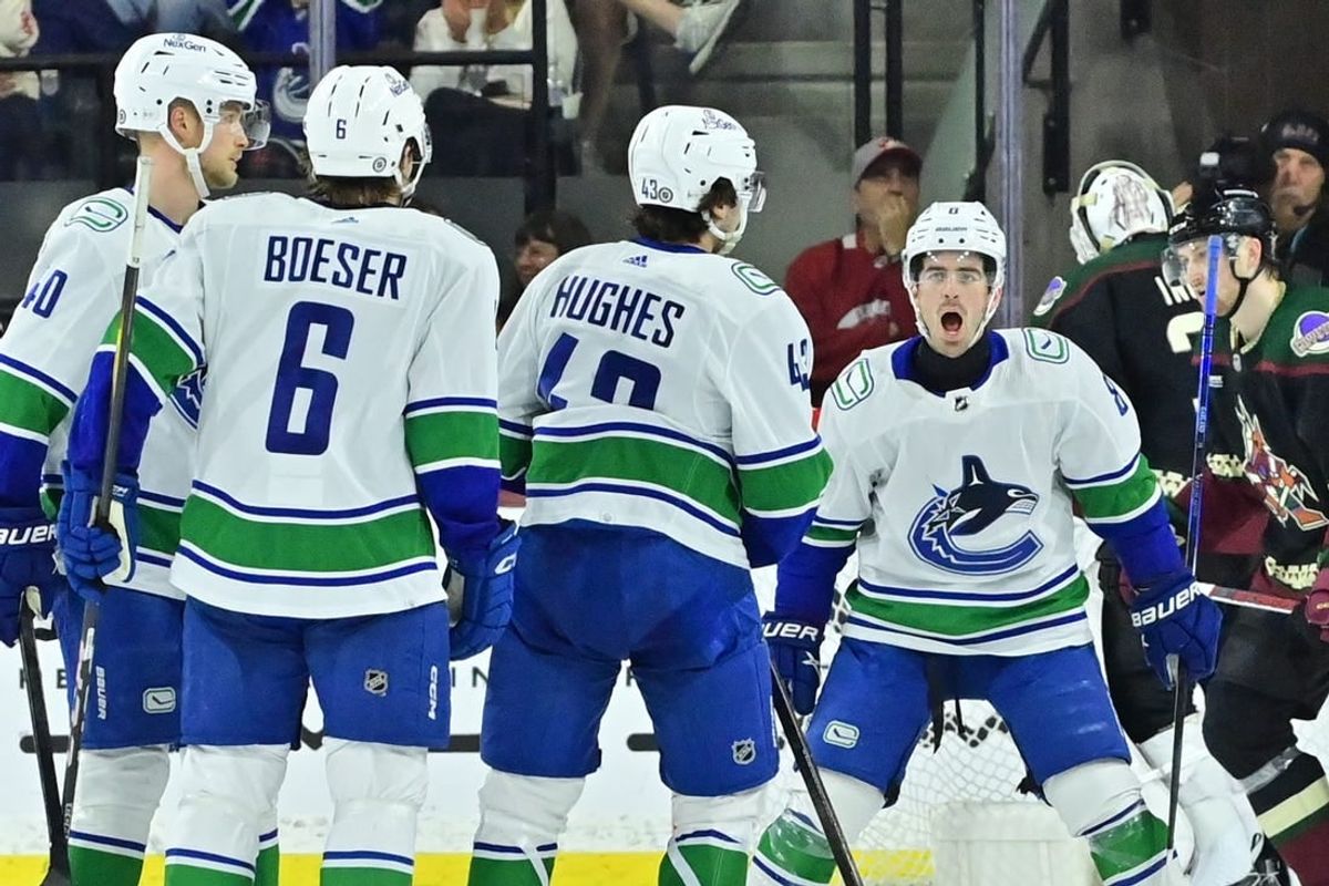 Apr 3, 2024; Tempe, Arizona, USA; Vancouver Canucks defenseman Quinn Hughes (43) celebrates with right wing Conor Garland (8) right wing Brock Boeser (6) and center Elias Pettersson (40) after scoring a goal in the second period against the Arizona Coyotes at Mullett Arena.