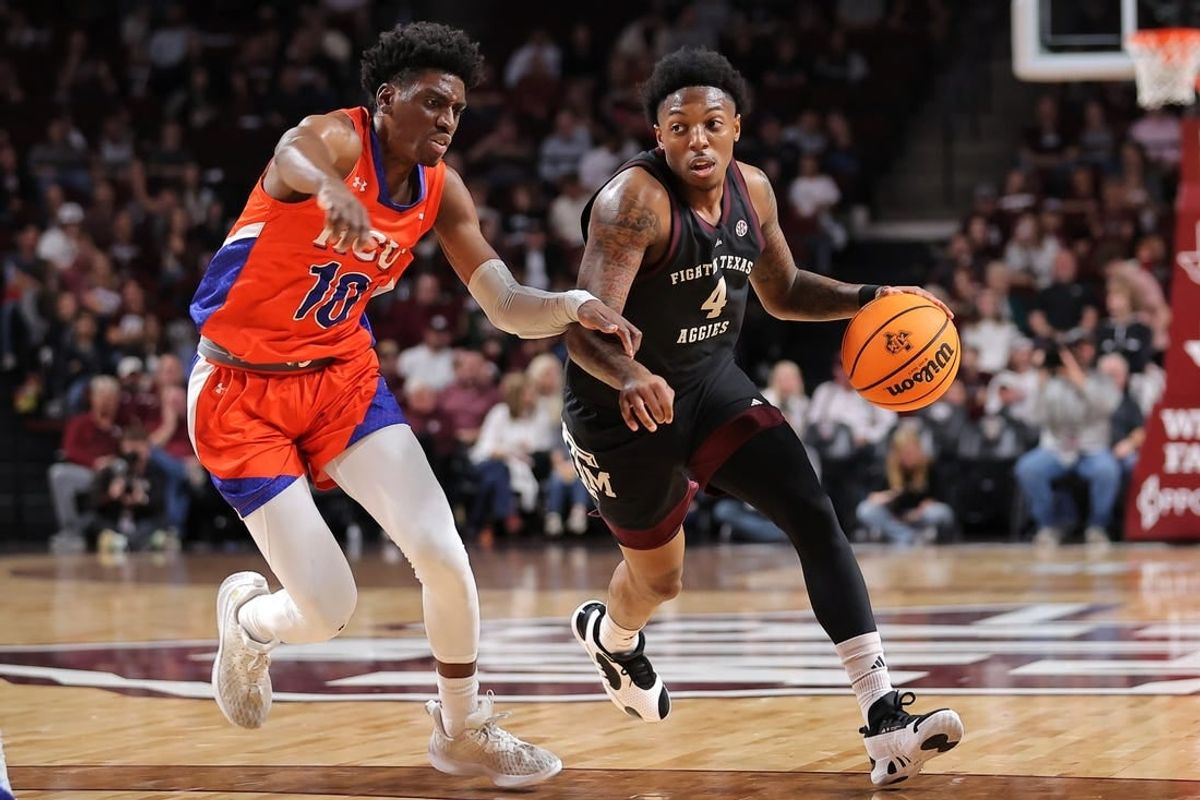 Dec 22, 2023; College Station, Texas, USA; Texas A&M Aggies guard Wade Taylor IV (4) handles the ball against Houston Christian Huskies guard Marcus Greene (10) during the first half at Reed Arena.