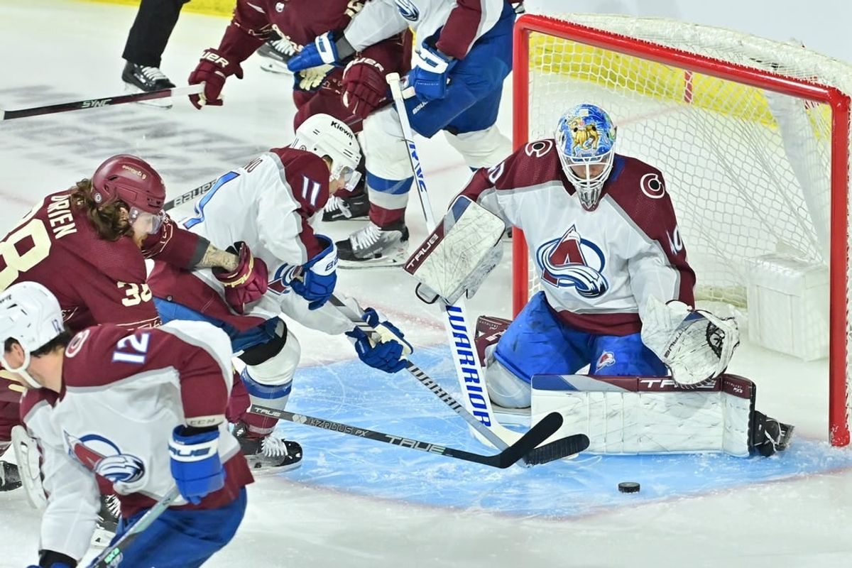 Dec 27, 2023; Tempe, Arizona, USA; Colorado Avalanche goaltender Alexandar Georgiev (40) and center Andrew Cogliano (11) defend as Arizona Coyotes center Liam O'Brien (38) attacks in the first period at Mullett Arena.