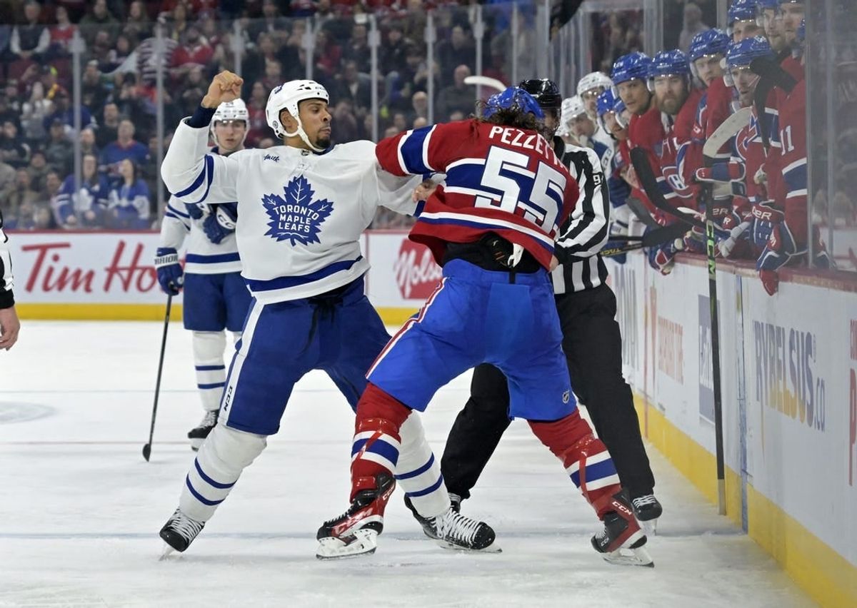 Apr 6, 2024; Montreal, Quebec, CAN; Toronto Maple Leafs forward Ryan Reaves (75) fights Montreal Canadiens forward Michael Pezzetta (55) during the second period at the Bell Centre.