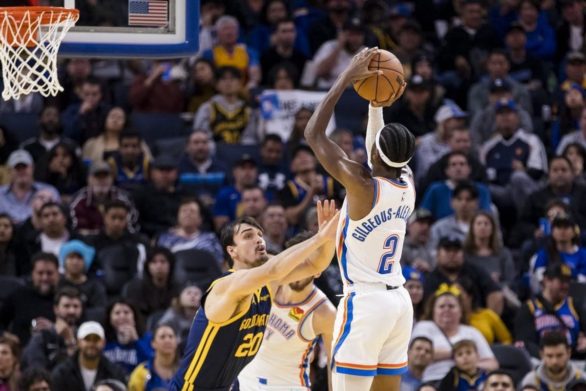 Nov 18, 2023; San Francisco, California, USA; Golden State Warriors center Dario Saric (20) defends Oklahoma City Thunder guard Shai Gilgeous-Alexander (2) during the second half at Chase Center.