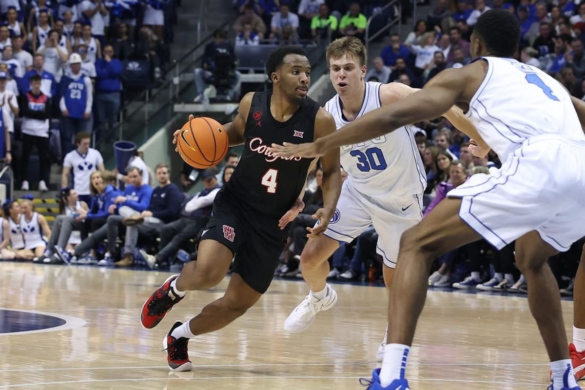 Jan 23, 2024; Provo, Utah, USA; Houston Cougars guard L.J. Cryer (4) dribbles past Brigham Young Cougars guard Dallin Hall (30) during the first half at Marriott Center.