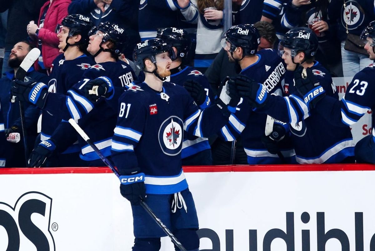 Apr 16, 2024; Winnipeg, Manitoba, CAN;  Winnipeg Jets forward Kyle Connor (81) is congratulated by his teammates after a goal against the Seattle Kraken during the first period at Canada Life Centre.