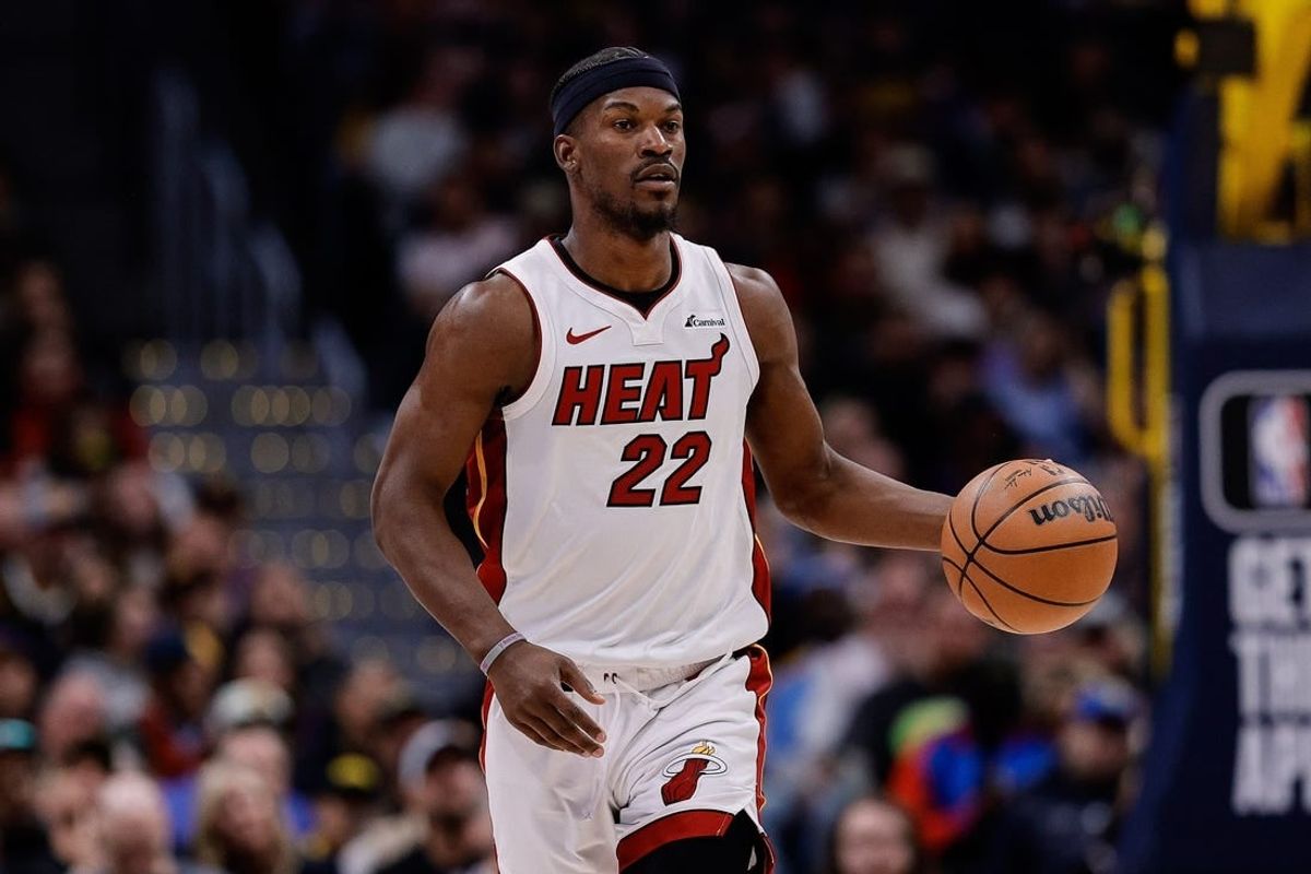 Feb 29, 2024; Denver, Colorado, USA; Miami Heat forward Jimmy Butler (22) dribbles the ball up court in the fourth quarter against the Denver Nuggets at Ball Arena.