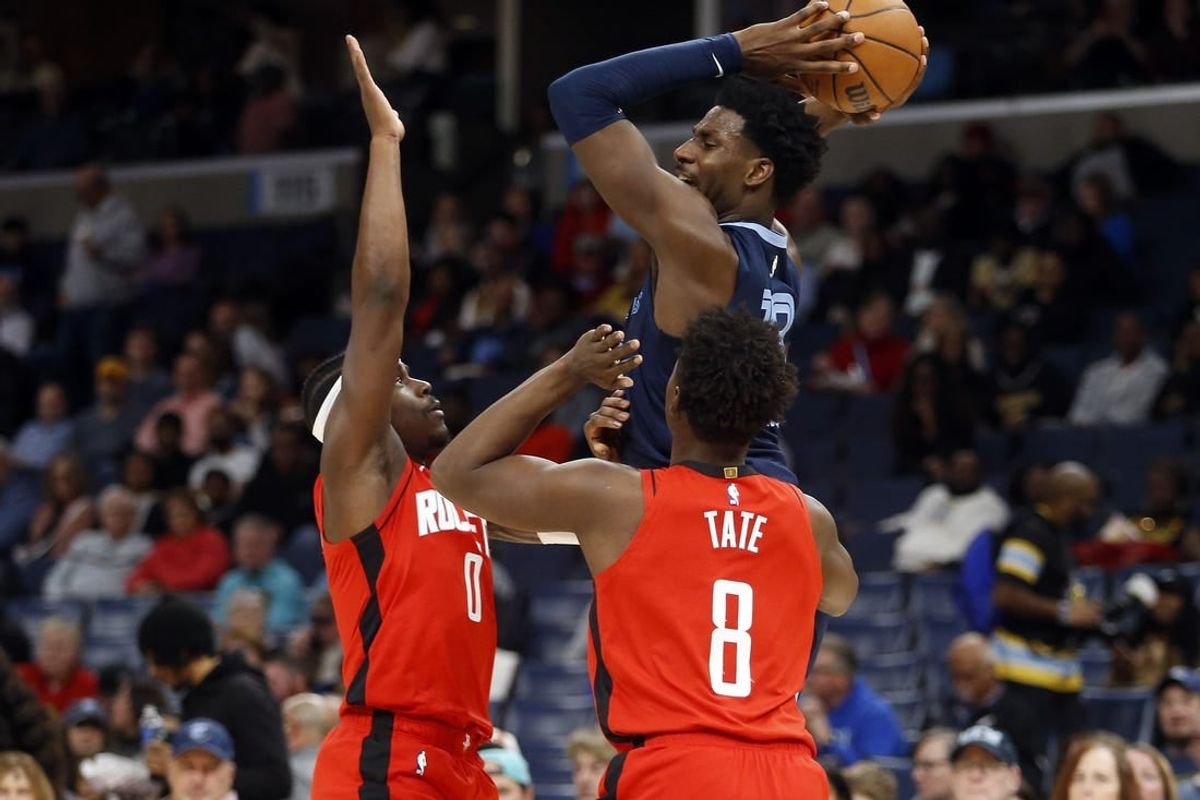 Feb 14, 2024; Memphis, Tennessee, USA; Memphis Grizzlies forward-center Jaren Jackson Jr. (13) passes the ball as Houston Rockets guard Aaron Holiday (0) and forward Jae'Sean Tate (8) defend during the first half at FedExForum.