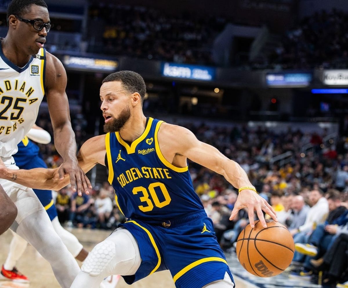 Feb 8, 2024; Indianapolis, Indiana, USA; Golden State Warriors guard Stephen Curry (30) dribbles the ball while Indiana Pacers forward Jalen Smith (25) defends in the first half at Gainbridge Fieldhouse.