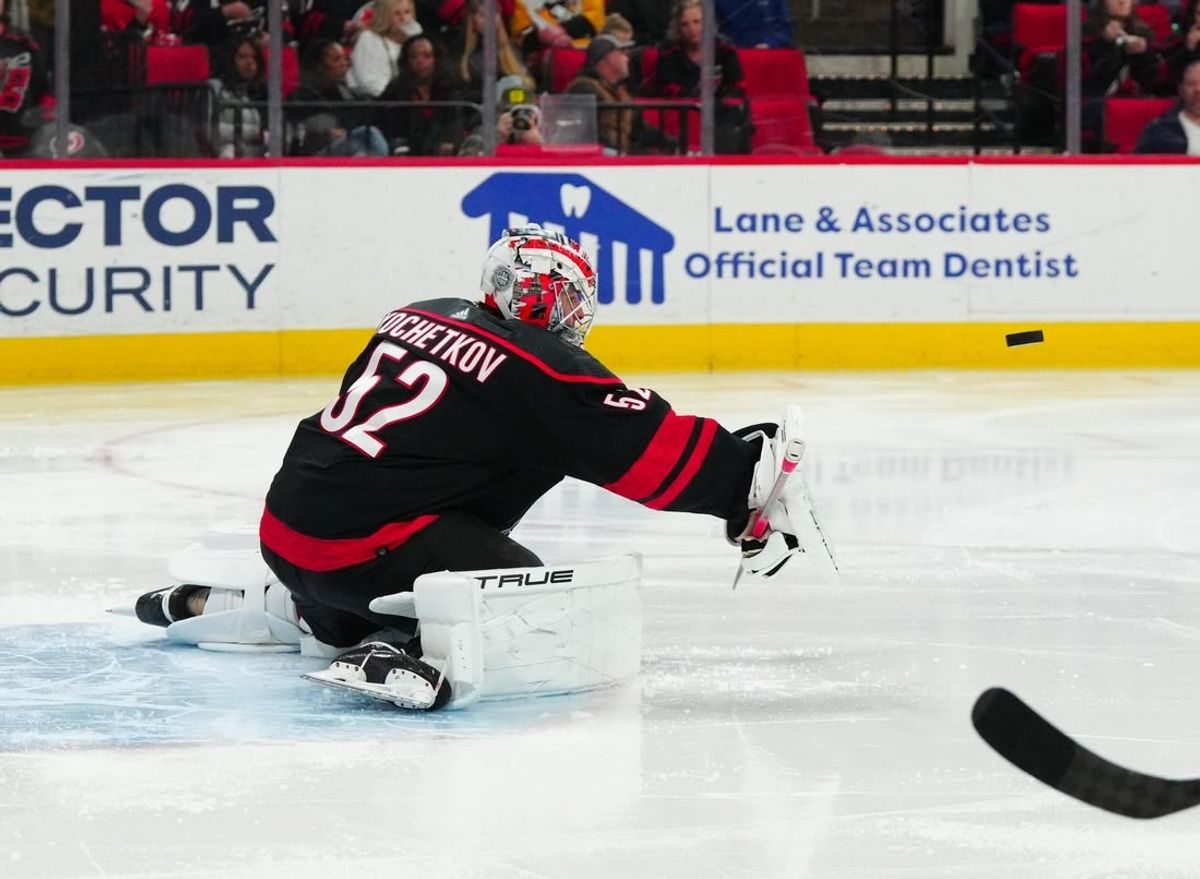 Feb 22, 2024; Raleigh, North Carolina, USA; Carolina Hurricanes goaltender Pyotr Kochetkov (52) makes a blocker save against the Florida Panthers during the second period at PNC Arena.