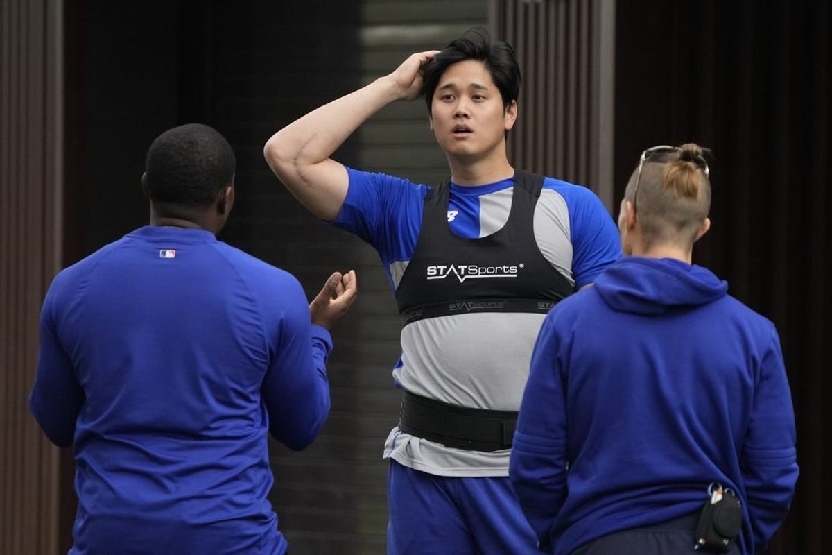 Feb 10, 2024; Glendale, AZ, USA; Los Angeles Dodgers designated hitter Shohei Ohtani (17) works out with trainers during spring training camp at Camelback Ranch.