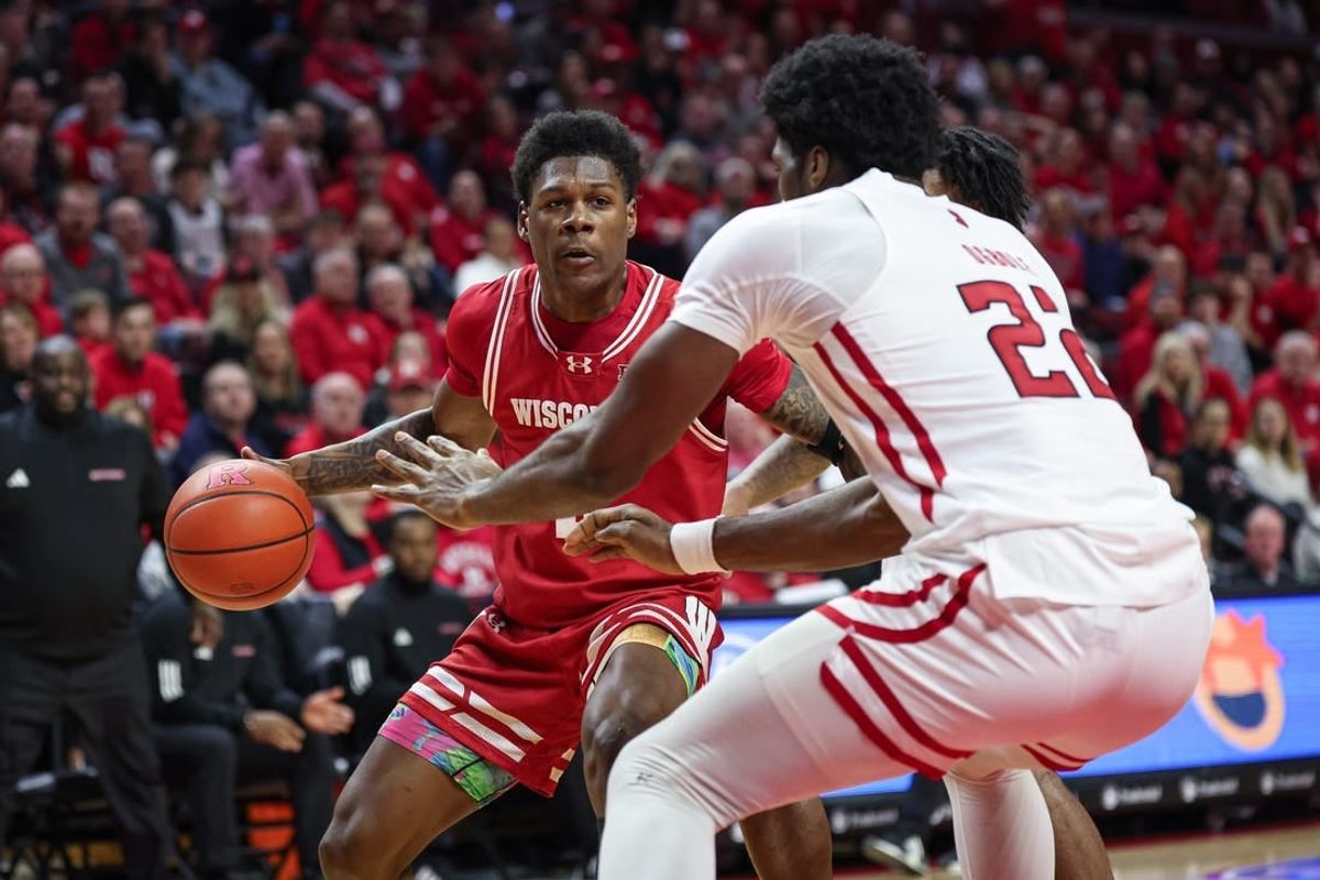 Feb 10, 2024; Piscataway, New Jersey, USA; Wisconsin Badgers guard AJ Storr (left) dribbles the ball against Rutgers Scarlet Knights center Emmanuel Ogbole (22) during the first half at Jersey Mike's Arena.