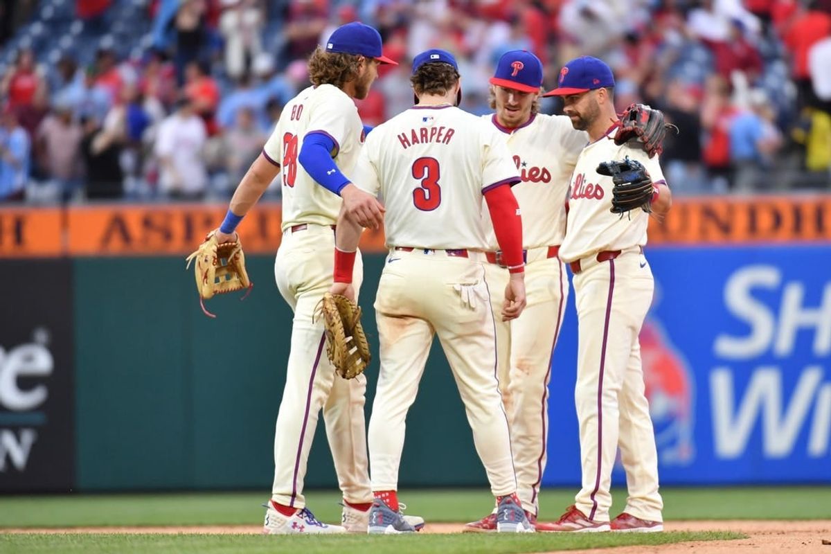 May 6, 2024; Philadelphia, Pennsylvania, USA;  Philadelphia Phillies third base Alec Bohm (28), first base Bryce Harper (3), second base Bryson Stott (5) and outfielder Whit Merrifield (9) celebrate win against the San Francisco Giants at Citizens Bank Park.