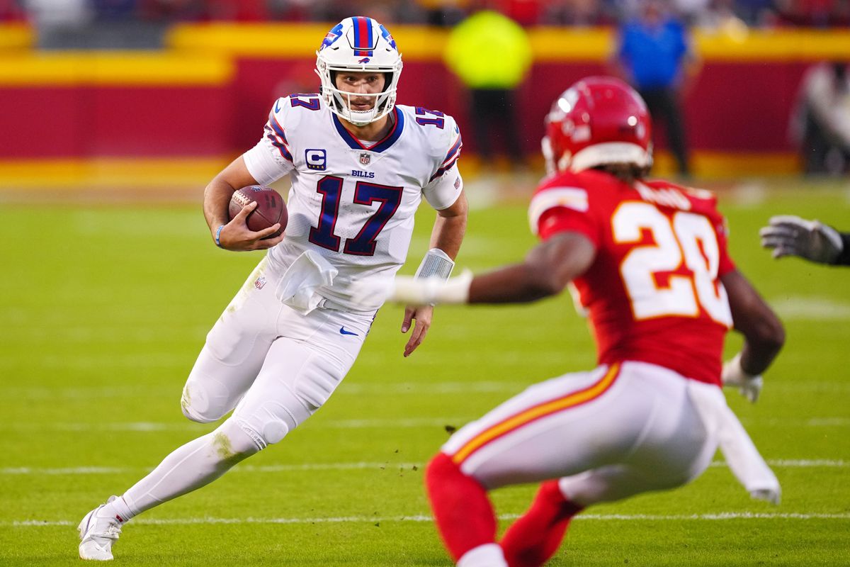 Josh Allen of the Buffalo Bills runs the ball against Justin Reid of the Kansas City Chiefs during a 2022 game at Arrowhead Stadium.