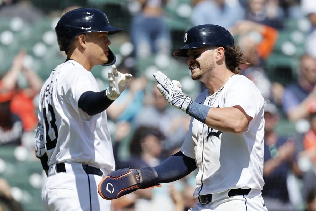 Apr 16, 2024; Detroit, Michigan, USA;  Detroit Tigers third baseman Zach McKinstry (39) receives congratulations from third baseman Gio Urshela (13) after scoring in the sixth inning against the Texas Rangers at Comerica Park.