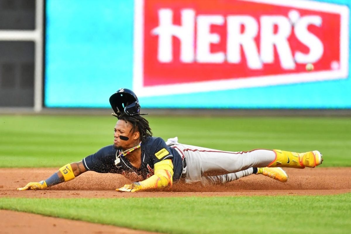Oct 11, 2023; Philadelphia, Pennsylvania, USA;  Atlanta Braves right fielder Ronald Acuna Jr. (13) slides into second base for a double during the third inning against the Philadelphia Phillies in game three of the NLDS for the 2023 MLB playoffs at Citizens Bank Park.