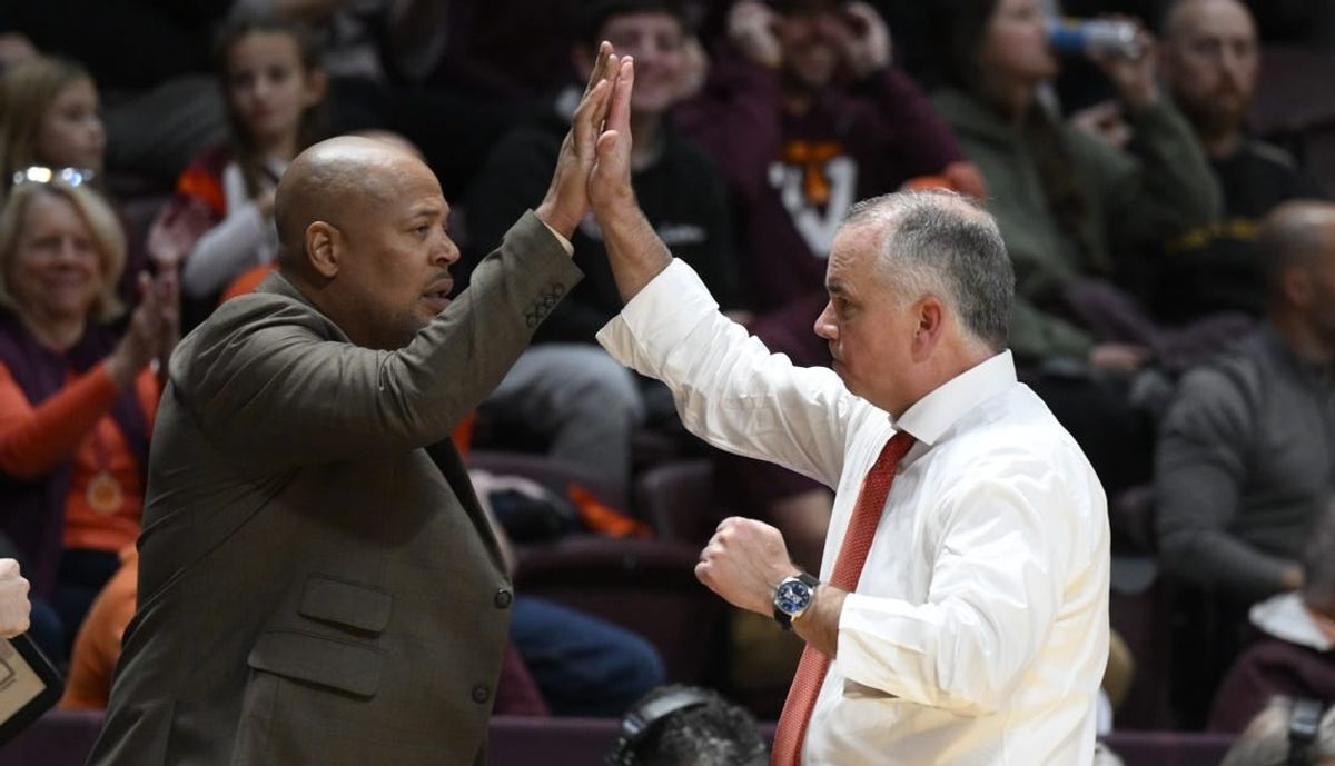 Nov 28, 2022; Blacksburg, Virginia, USA; Virginia Tech Hokies head coach Mike Young (right) high fives his assistant coach Mike Jones during the second half against the Minnesota Golden Gophers at Cassell Coliseum.