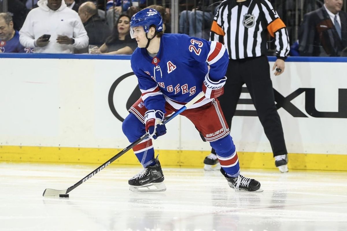 Dec 27, 2023; New York, New York, USA; New York Rangers defenseman Adam Fox (23) controls the puck in the third period against the Washington Capitals at Madison Square Garden.