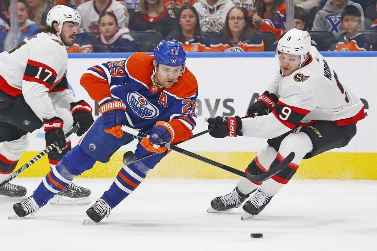 Jan 6, 2024; Edmonton, Alberta, CAN; Edmonton Oilers forward Leon Draisaitl (29) carries the puck around Ottawa Senators forward Josh Norris (9) during the first period at Rogers Place.