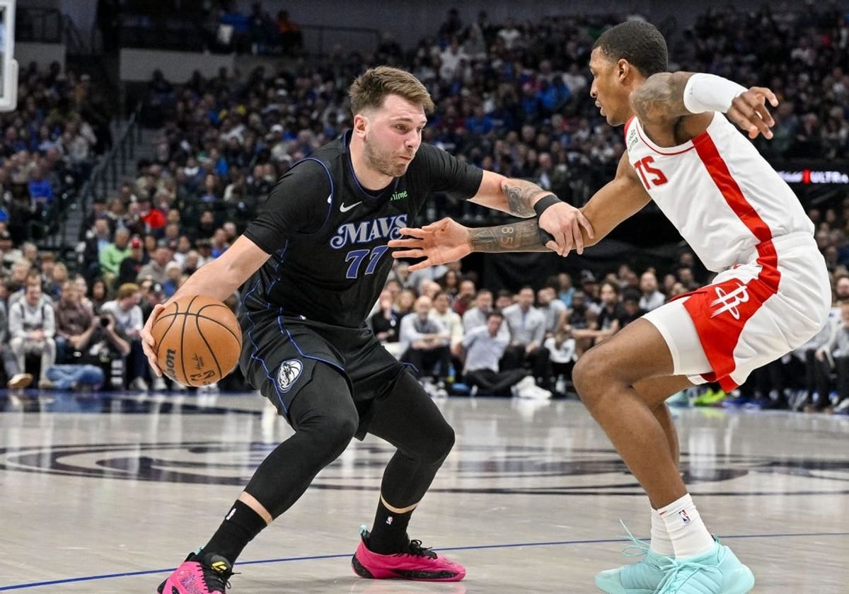 Nov 28, 2023; Dallas, Texas, USA; Dallas Mavericks guard Luka Doncic (77) looks to move the ball past Houston Rockets forward Jabari Smith Jr. (10) during the second quarter at the American Airlines Center.