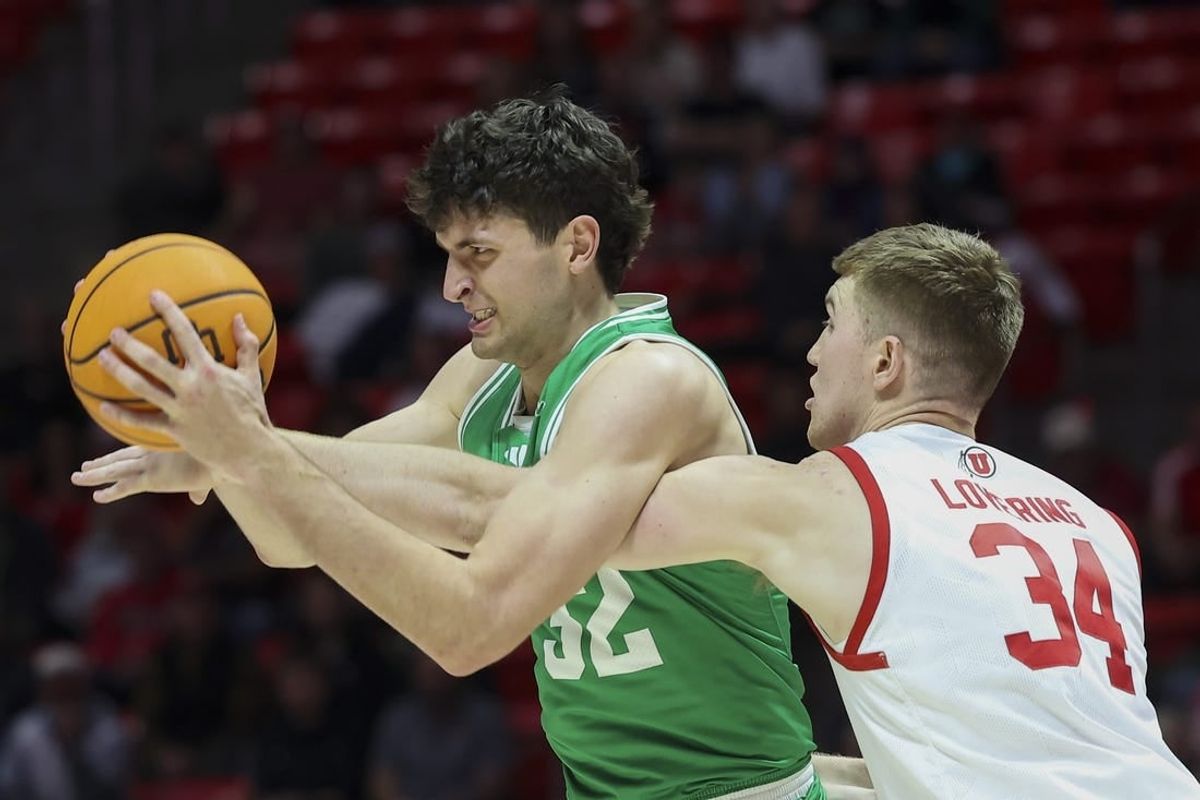 Dec 16, 2023; Salt Lake City, Utah, USA; Utah Valley Wolverines center Trevin Dorius (32) has the ball knocked away by Utah Utes center Lawson Lovering (34) during the first half at Jon M. Huntsman Center.