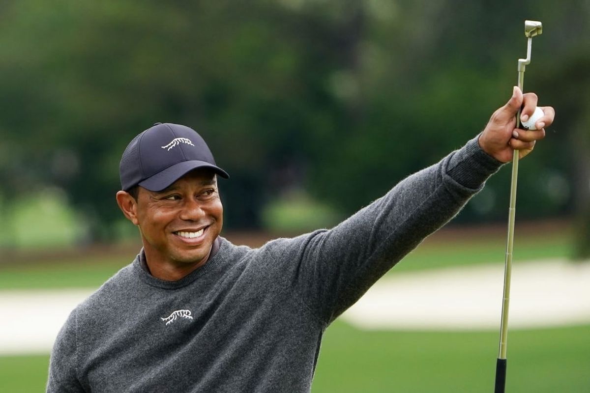 Apr 9, 2024; Augusta, Georgia, USA; Tiger Woods gives a thumbs up to the crowd on the no. 9 green during a practice round for the Masters Tournament golf tournament at Augusta National Golf Club.