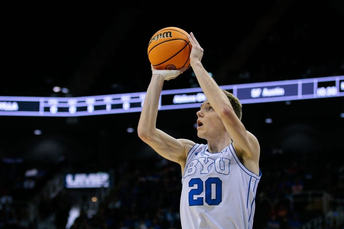 Mar 13, 2024; Kansas City, MO, USA; Brigham Young Cougars guard Spencer Johnson (20) shoots the ball during the first half against the UCF Knights at T-Mobile Center.