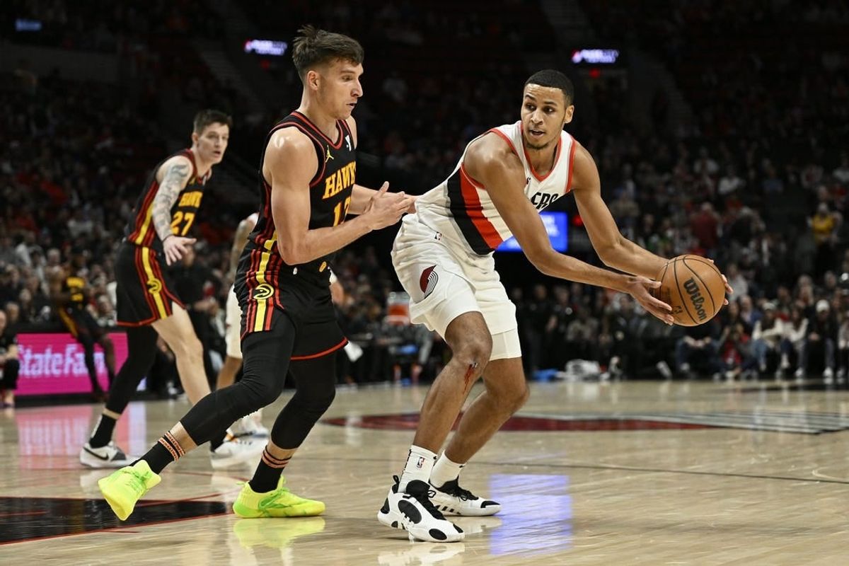 Mar 13, 2024; Portland, Oregon, USA; Portland Trail Blazers forward Kris Murray (8) looks for an opening during the first half against Atlanta Hawks guard Bogdan Bogdanovic (13) at Moda Center.