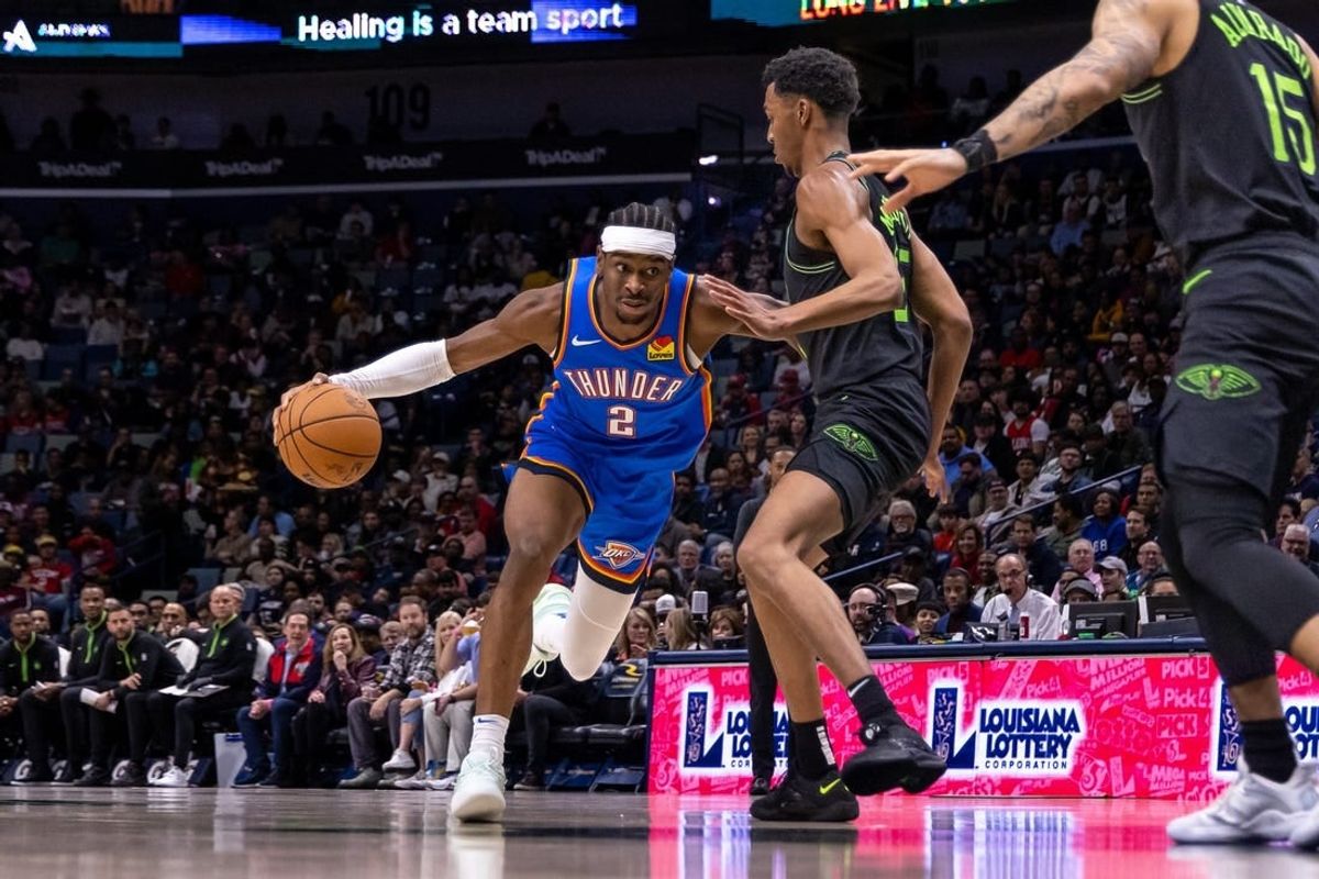 Jan 26, 2024; New Orleans, Louisiana, USA; Oklahoma City Thunder guard Shai Gilgeous-Alexander (2) dribbles against New Orleans Pelicans guard Trey Murphy III (25) during the first half at Smoothie King Center.