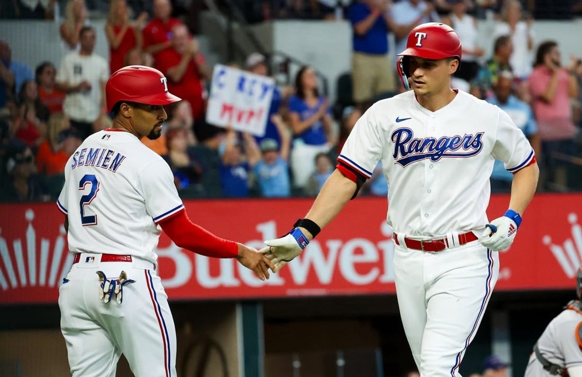 Sep 4, 2023; Arlington, Texas, USA;  Texas Rangers shortstop Corey Seager (5) celebrates with Texas Rangers second baseman Marcus Semien (2) after hitting a two run home run during the first inning against the Houston Astros at Globe Life Field.