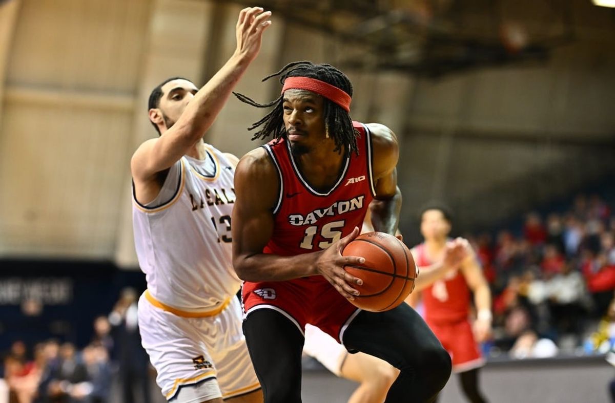 Jan 23, 2024; Philadelphia, Pennsylvania, USA; Dayton Flyers forward DaRon Holmes II (15) controls the ball against La Salle Explorers guard Daeshon Shepherd (13) in the first half at Tom Gola Arena at TruMark Financial Center.