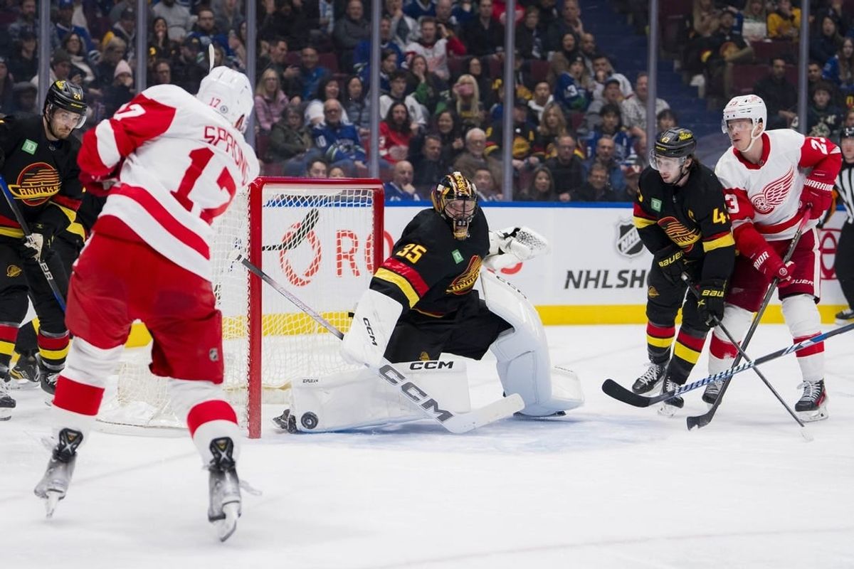 Feb 15, 2024; Vancouver, British Columbia, CAN; Vancouver Canucks goalie Thatcher Demko (35) makes a save on Detroit Red Wings forward Daniel Sprong (17)  in the second period at Rogers Arena.