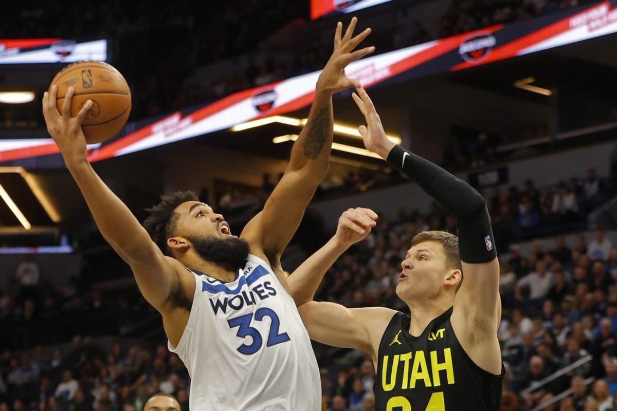 Nov 30, 2023; Minneapolis, Minnesota, USA; Minnesota Timberwolves forward Karl-Anthony Towns (32) shoots against Utah Jazz center Walker Kessler (24) in the first quarter at Target Center.