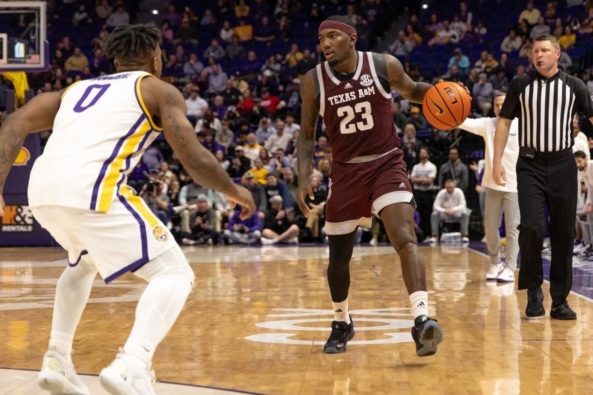 Jan 20, 2024; Baton Rouge, Louisiana, USA;  Texas A&M Aggies guard Tyrece Radford (23) dribbles against LSU Tigers guard Trae Hannibal (0) during the second half at Pete Maravich Assembly Center.