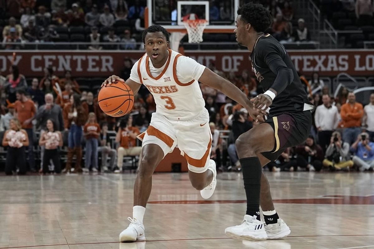 Nov 30, 2023; Austin, Texas, USA; Texas Longhorns guard Max Abmas (3) looks to pass the ball while defended by Texas State Bobcats guard Dylan Dawson (0) during the second half at Moody Center.