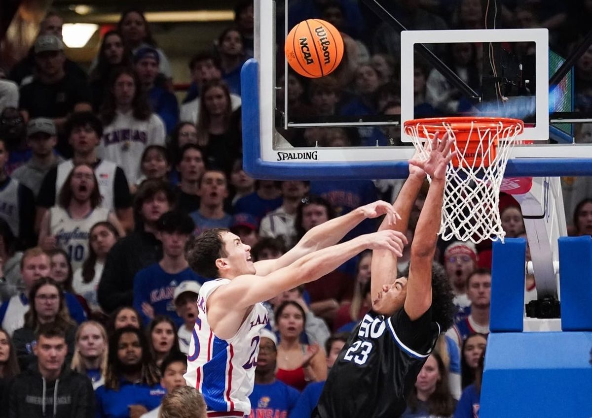 Nov 28, 2023; Lawrence, Kansas, USA; Kansas Jayhawks guard Nicolas Timberlake (25) shoots as Eastern Illinois Panthers forward Rodolfo Bolis (23) attempts to block during the first half at Allen Fieldhouse.