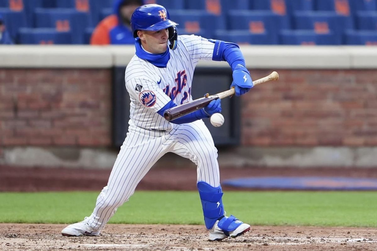 Apr 4, 2024; New York City, New York, USA; New York Mets third baseman Zack Short (21) lays down a sacrifice bunt against the Detroit Tigers during the eighth inning at Citi Field.