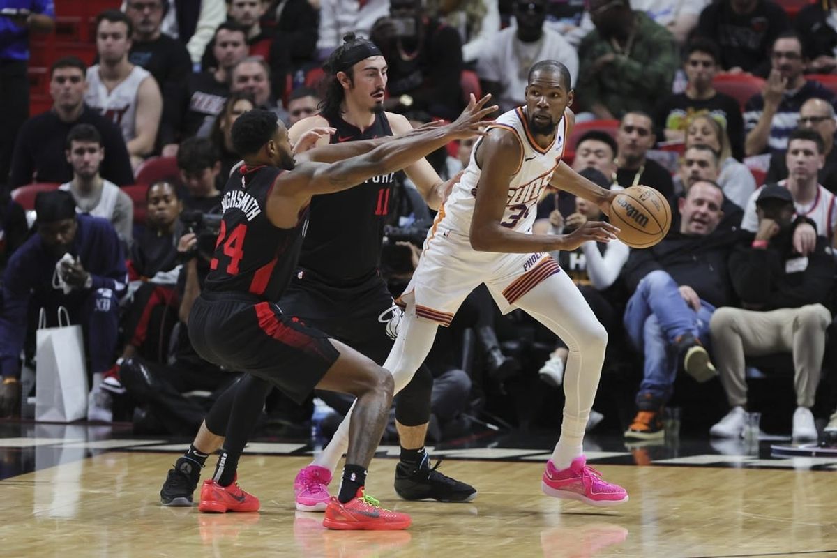 Jan 29, 2024; Miami, Florida, USA; Phoenix Suns forward Kevin Durant (35) protects the basketball from Miami Heat forward Haywood Highsmith (24) and guard Jaime Jaquez Jr. (11) during the third quarter at Kaseya Center.