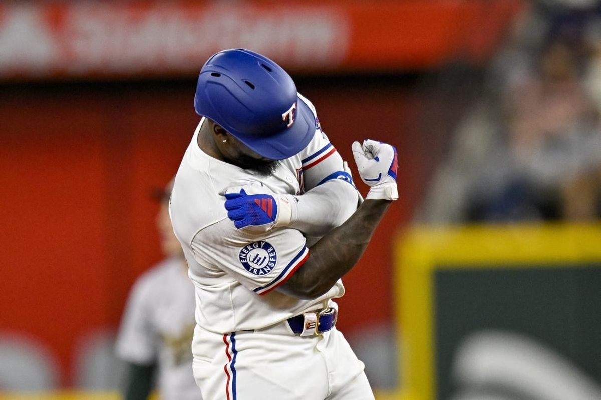 Apr 10, 2024; Arlington, Texas, USA; Texas Rangers right fielder Adolis Garcia (53) celebrates at second base after he hits a double against the Oakland Athletics during the third inning at Globe Life Field.