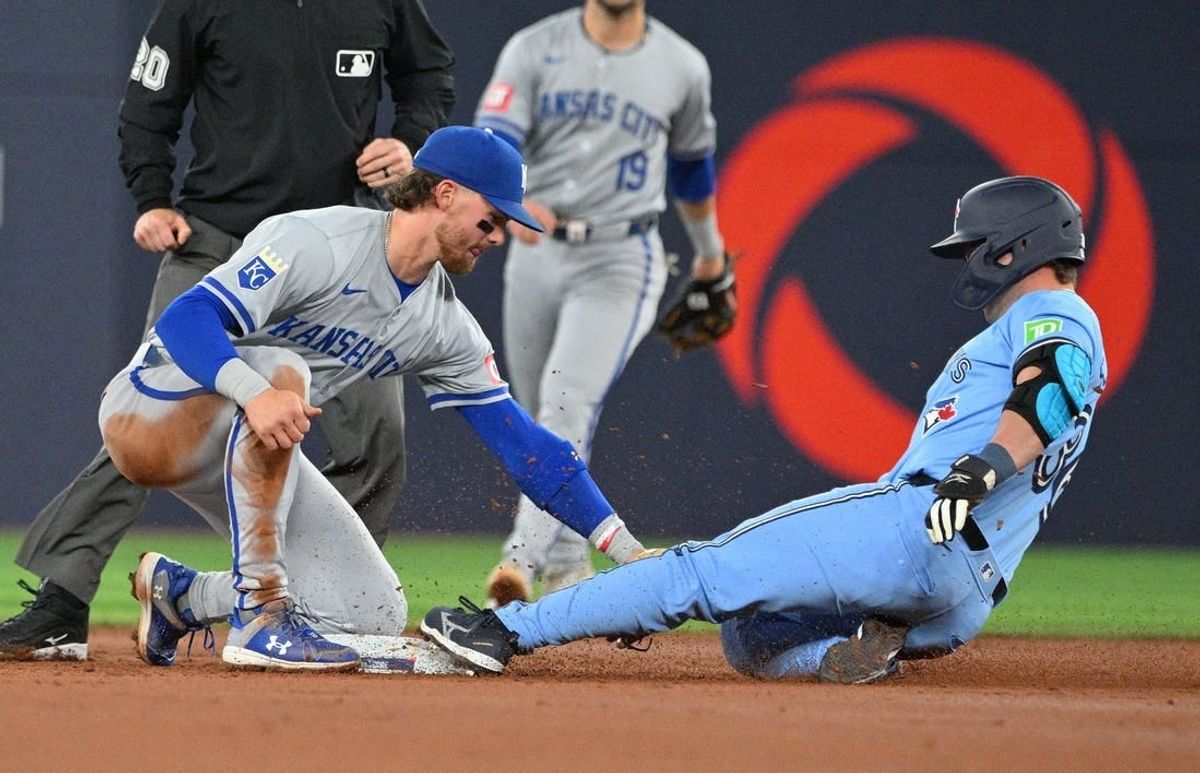 Apr 30, 2024; Toronto, Ontario, CAN;   Toronto Blue Jays left fielder Davis Schneider (36) is tagged out by Kansas City Royals shortstop Bobby Witt Jr. (7) trying to stretch a single into a double in the second inning at Rogers Centre.