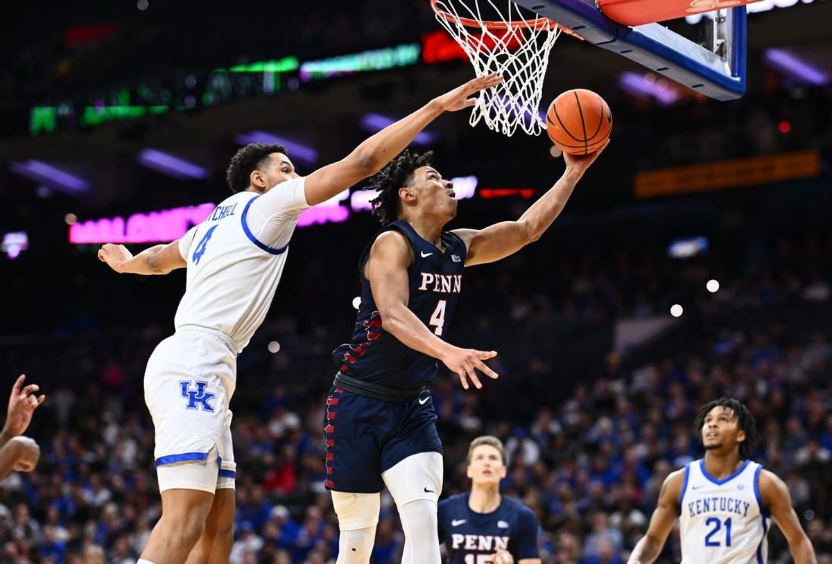 Dec 9, 2023; Philadelphia, Pennsylvania, USA; Penn Quakers guard Tyler Perkins (4) shoots the ball against Kentucky Wildcats forward Tre Mitchell (4) in the first half at Wells Fargo Center.