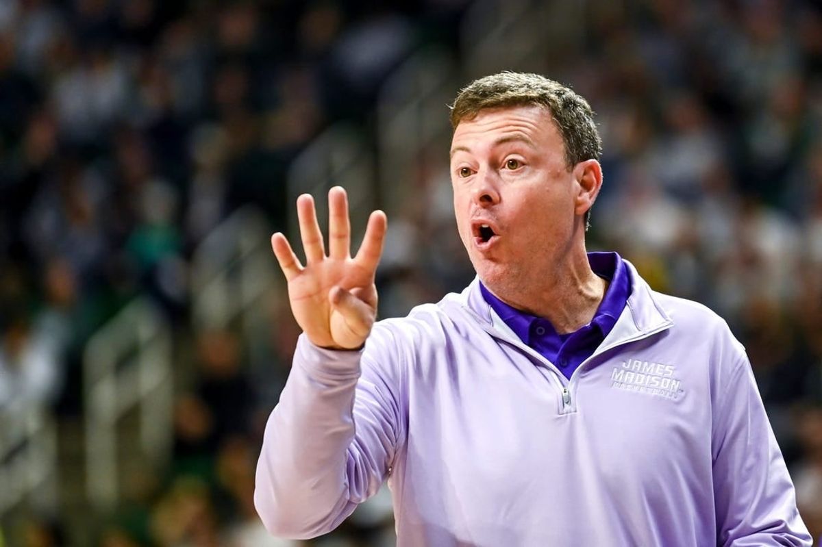 James Madison's head coach Mark Byington talks to a referee during the first half in the game against Michigan State on Monday, Nov. 6, 2023, in East Lansing.
