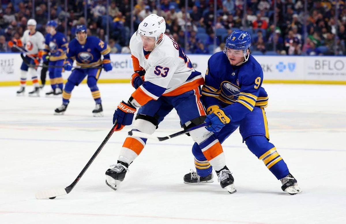 Mar 14, 2024; Buffalo, New York, USA;  New York Islanders center Casey Cizikas (53) controls the puck as Buffalo Sabres left wing Zach Benson (9) defends during the second period at KeyBank Center.