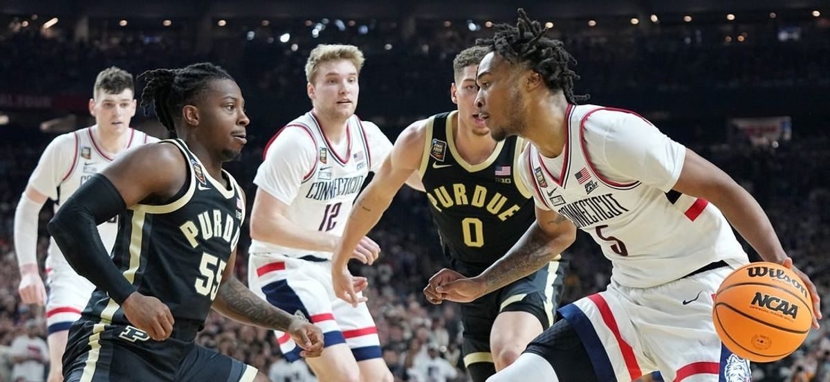 Purdue Boilermakers guard Lance Jones (55) defends Connecticut Huskies guard Stephon Castle (5) during the NCAA Men’s Basketball Tournament Championship, Monday, April 8, 2024, at State Farm Stadium in Glendale, Ariz.