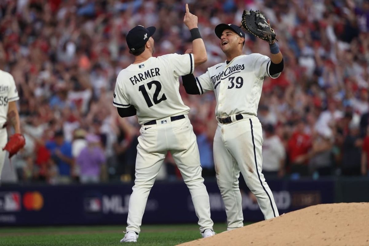 Oct 3, 2023; Minneapolis, Minnesota, USA; Minnesota Twins third baseman Kyle Farmer (12) and first baseman Donovan Solano (39) celebrated after defeating Toronto Blue Jays  during game one of the Wildcard series for the 2023 MLB playoffs at Target Field.
