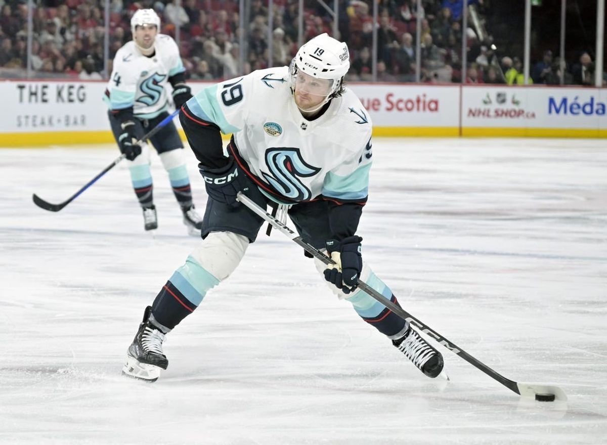 Dec 4, 2023; Montreal, Quebec, CAN; Seattle Kraken forward Jared McCann (19) takes a shot on net during the third period of the game against the Montreal Canadiens at the Bell Centre.