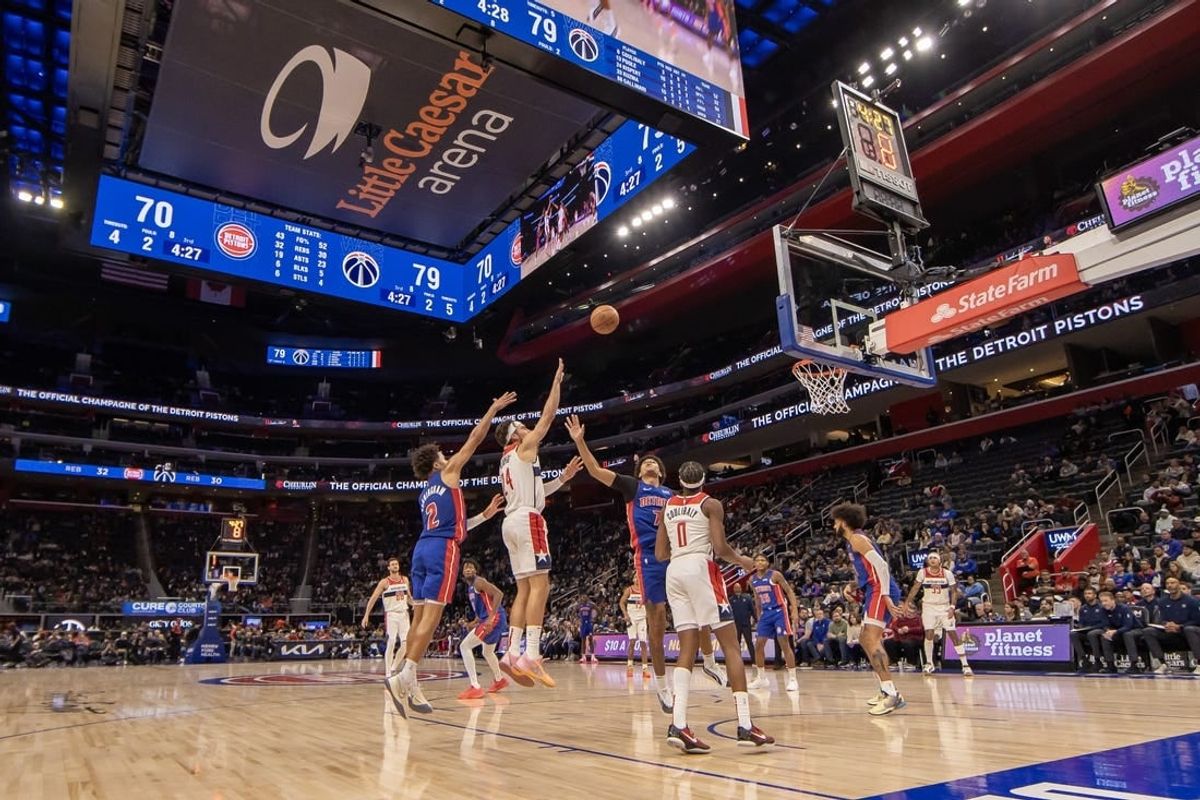 Nov 27, 2023; Detroit, Michigan, USA; Washington Wizards forward Corey Kispert (24) shoots the ball between Detroit Pistons guard Cade Cunningham (2) and guard Killian Hayes (7) during the second half at Little Caesars Arena.